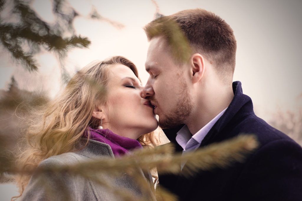 man and woman kissing